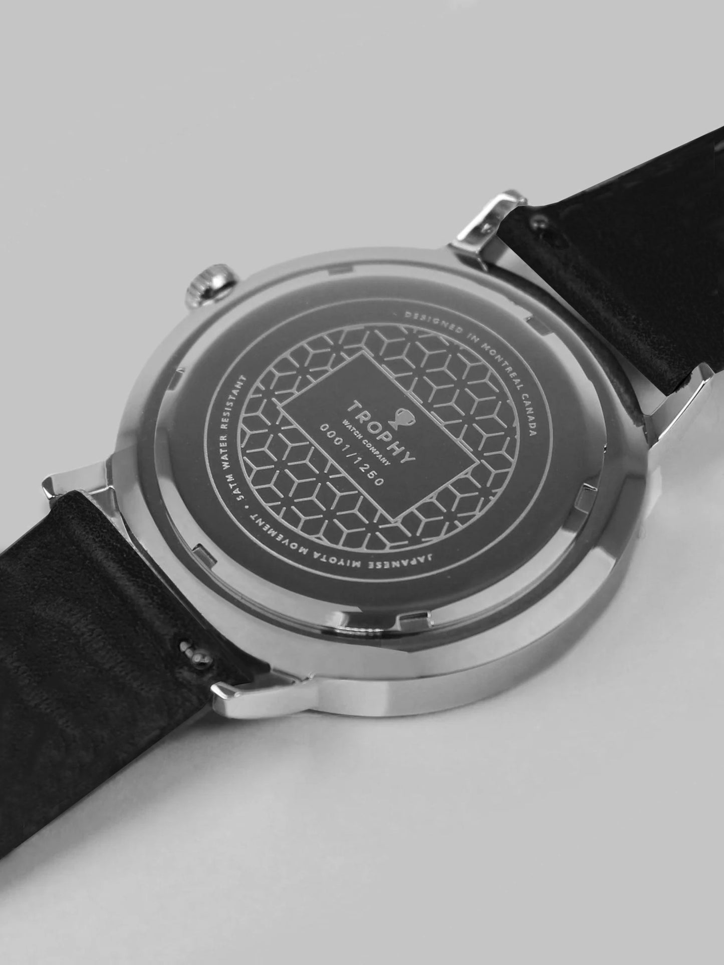 Trophy Watch Company | 40mm STERLING PERLON: The Sterling combines a silver-white dial and black and grey woven perlon strap for a look that’s crisp, neutral, and refined. Its polished 40mm stainless steel case keeps a slim profile, making it effortlessly